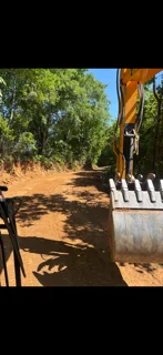 Excavated dirt lot with cleared vegetation and graded soil for foundation work